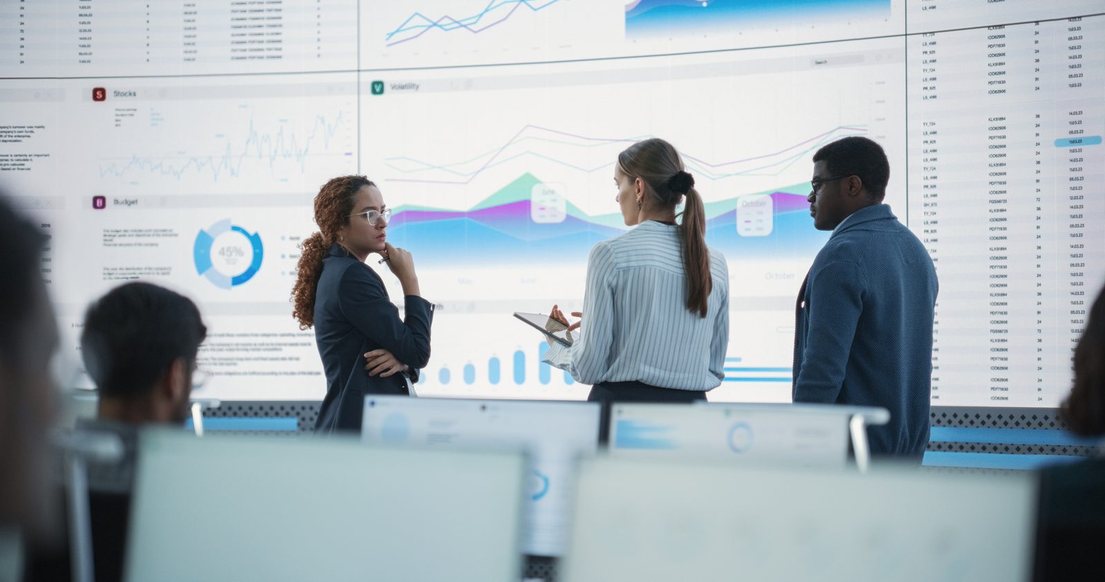 Executive team reviewing an AI strategy on a wall display in a modern conference room